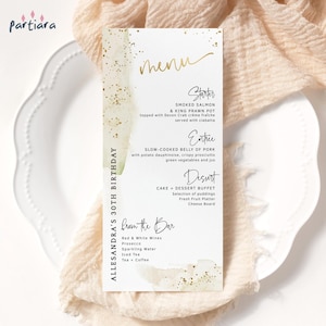 May include: A menu card with gold text and watercolor accents. The menu includes a starter of smoked salmon and king prawn pot, an entree of slow-cooked belly of pork, and a dessert buffet. The card is for Alessandra's 30th birthday.