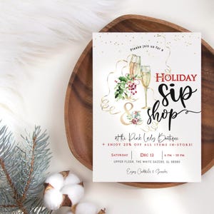 May include: A white invitation card with the text "HOLIDAY Sip Shop" and event details. The card features illustrations of champagne glasses, greenery, and gold accents. The event is at the Pink Lady Boutique.