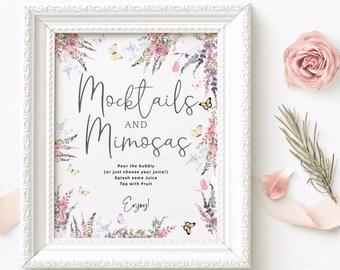 May include: A printable sign with a floral design and butterflies. The sign says "Mocktails and Mimosas" and includes instructions for making the drinks. The sign is framed in a white frame.