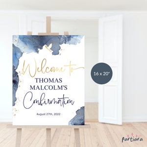 Puede incluir: Un letrero blanco sobre un caballete con el texto "Welcome to THOMAS MALCOLM'S Confirmation" en oro y azul marino. El letrero mide 40,6 x 50,8 cm y presenta detalles en acuarela azul con motas doradas. También se incluye la fecha "27 de agosto de 2022".