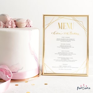 Op de afbeelding: Een gouden menukaart met een geometrisch ontwerp en de tekst "MENU Caloin's 30th Birthday" in gouden letters. De menukaart bevat een driegangenmenu met een dessertbuffet.