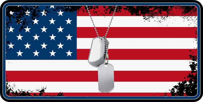 May include: Two silver dog tags on a chain, hanging in front of an American flag with red and white stripes and blue stars. The flag has a distressed, vintage look.