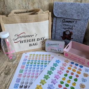 May include: A jute tote bag with the text "Summer's Weigh Day Bag" printed on it.  A grey felt pouch with the text "Summer's Weigh Day Essentials" printed on it. A small pink tray with the text "Summer's Treat Tray" printed on it. A metal tin with the text "Summer's Emergency Snacks" printed on it. A sheet of stickers with various designs, including stars, apples, and cupcakes. A sheet of stickers with various designs, including scales and the text "Weigh Day".