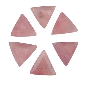 May include: Six pink triangle-shaped gemstones with a smooth, polished finish. The gemstones are arranged in a circle on a white background.
