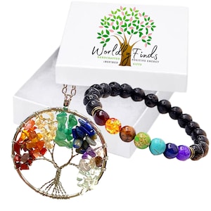 May include: A set of two chakra jewelry pieces, a necklace and a bracelet. The necklace features a silver wire wrapped tree of life design with seven chakra stones. The bracelet is made of black lava beads with seven chakra stones.