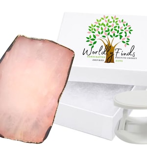 May include: A pink agate coaster with a gold rim, packaged in a white box with the logo "Worldly Finds Handcrafted Inspired Positive Energy Gifts".