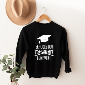May include: Black sweatshirt with a white graduation cap graphic and the text "Schools out for summer forever!" printed on the front.