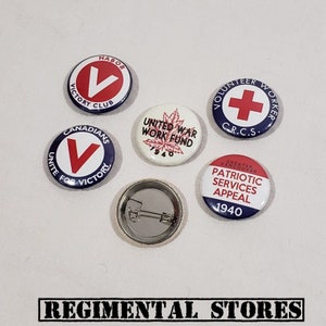 May include: Five vintage button pins with red, white, and blue colors. The pins feature various designs, including a red V, a red cross, a maple leaf, and text that reads "United War Work Fund 1940" and "Patriotic Services Appeal 1940".