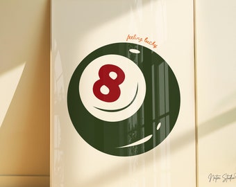 May include: A white poster with a green 8-ball illustration and the text "feeling lucky". The poster is framed in a light wood frame.
