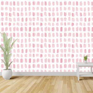 Puede incluir: Una pared blanca con un patr&oacute;n de puntos de acuarela rosa. Una planta en maceta y una peque&ntilde;a mesa blanca est&aacute;n en primer plano.