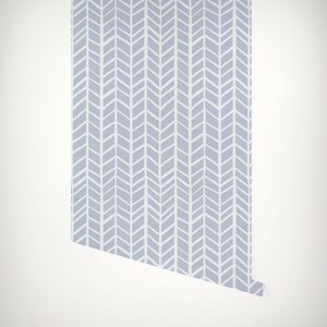May include: A roll of light blue wallpaper with a white chevron pattern.