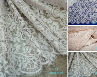 May include: Close-up of four different lace fabrics in white, peach, pale mint, and gray. The lace has a floral pattern. #1 pale mint, #2 white, #3 peach, #4 gray.