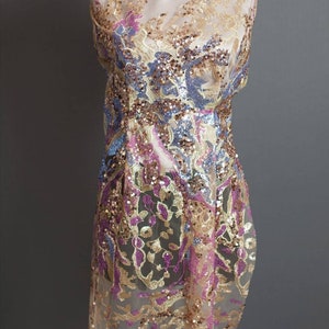 May include: A sheer fabric with a floral pattern embroidered with gold, pink, and blue sequins.