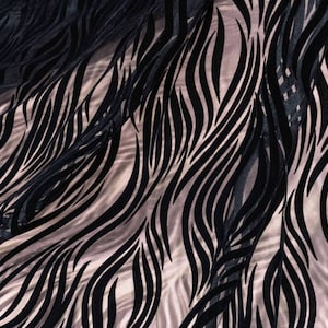 May include: Black and white patterned sheer fabric with a wavy design. The fabric is translucent and has a soft, flowing texture.