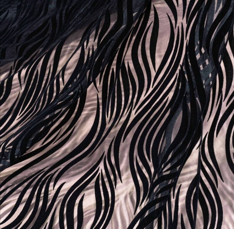 May include: Black and white patterned sheer fabric with a wavy design. The fabric is translucent and has a soft, flowing texture.
