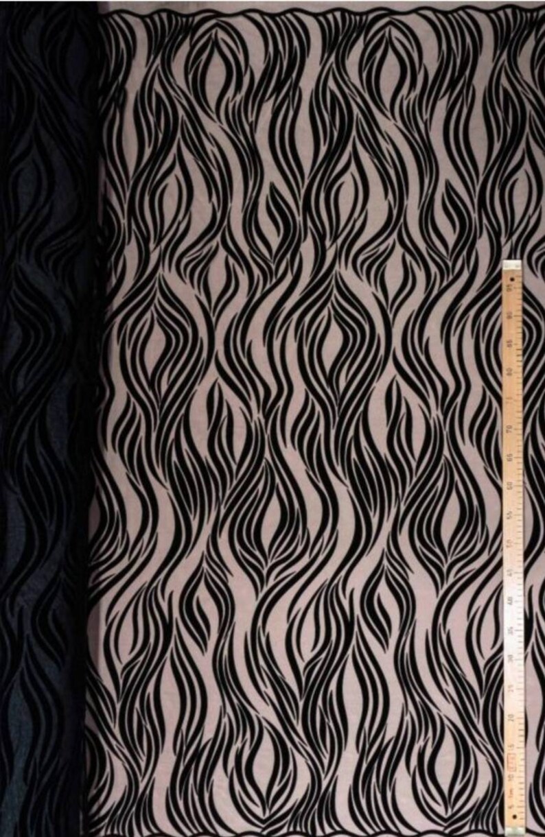 May include: Black and beige fabric with a wavy, abstract pattern. The fabric is sheer and has a delicate texture.