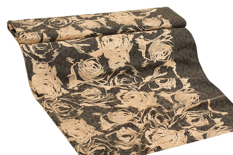 May include: A fabric with a dark brown background and a pattern of beige roses. The roses are stylized and have a slightly distressed look.