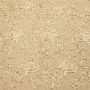 May include: A beige fabric with a raised embossed pattern of white roses. The fabric has a subtle sheen and a soft texture.