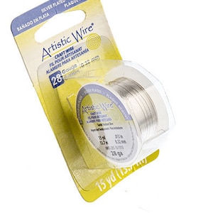 May include: A spool of silver plated Artistic Wire craft wire. The spool is labeled with the gauge, 28, and the length, 15 yards. The wire is 0.32 mm in diameter.