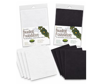 May include: Two packages of Beading Foundation for bead embroidery, cabochon beading, and sewing. One package contains white rectangular sheets, and the other contains black rectangular sheets. Each package features product text and graphics.