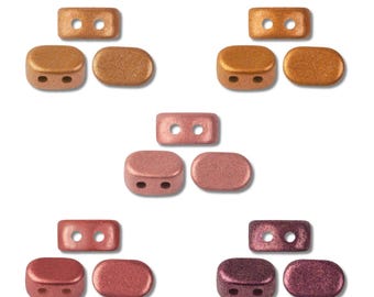 May include: A collection of fifteen small, oval-shaped beads arranged in five sets of three. Each set includes one bead with two holes and two solid beads in varying metallic shades of copper, bronze, rose gold, red, and deep purple.