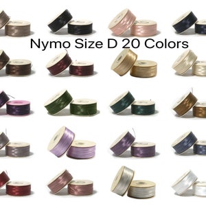 May include: Twenty spools of Nymo thread in size D, in a variety of colors, including black, brown, beige, pink, green, gray, purple, blue, red, and white.