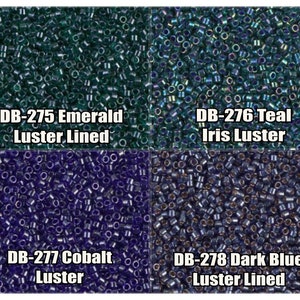 May include: Four different colors of seed beads, each in a square section. The top left section is emerald green luster lined seed beads. The top right section is teal iris luster seed beads. The bottom left section is cobalt blue luster seed beads. The bottom right section is dark blue luster lined seed beads.  DB-275 Emerald Luster Lined, DB-276 Teal Iris Luster, DB-277 Cobalt Luster, DB-278 Dark Blue Luster Lined.