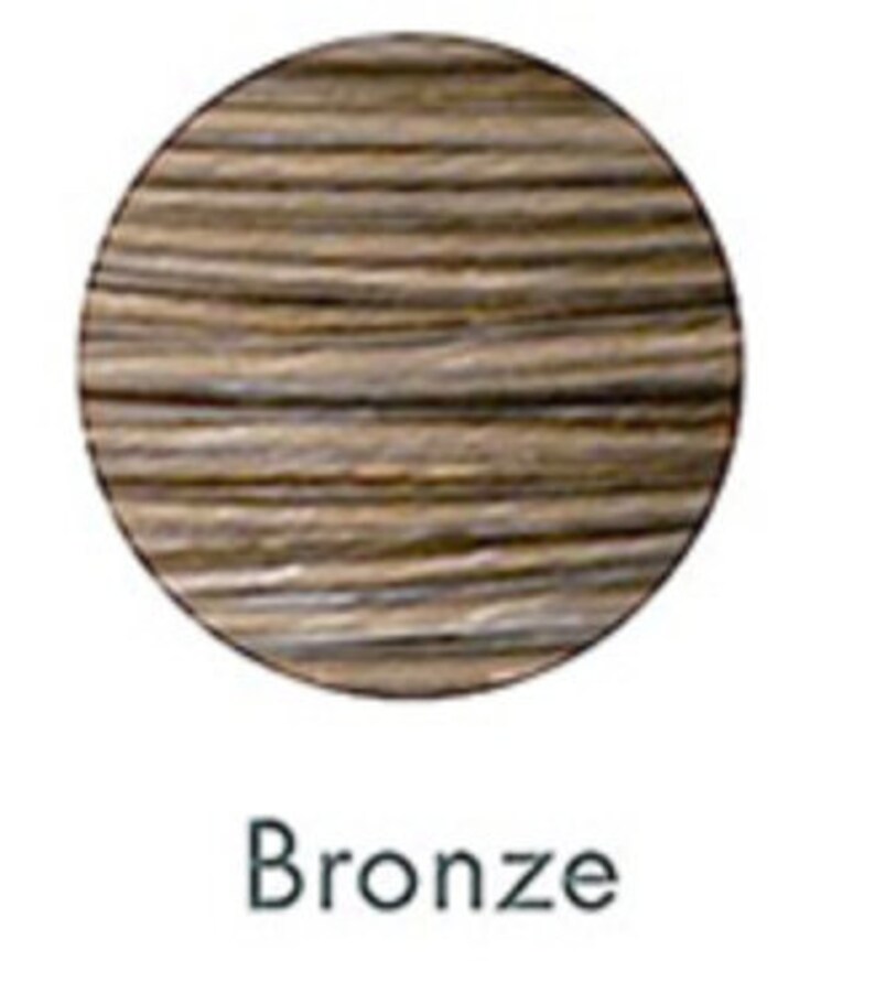 May include: A circular swatch of bronze-colored hair dye, showcasing a blend of brown and gold tones. The word "Bronze" is printed in a black, sans-serif font below the swatch, indicating the color name.