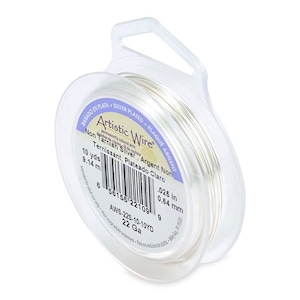 May include: A spool of silver-plated wire in a clear plastic container. The label reads "Artistic Wire Non Tarnish Silver Argent Non Ternissant, Plateado Claro" and includes the gauge, length, and dimensions of the wire.