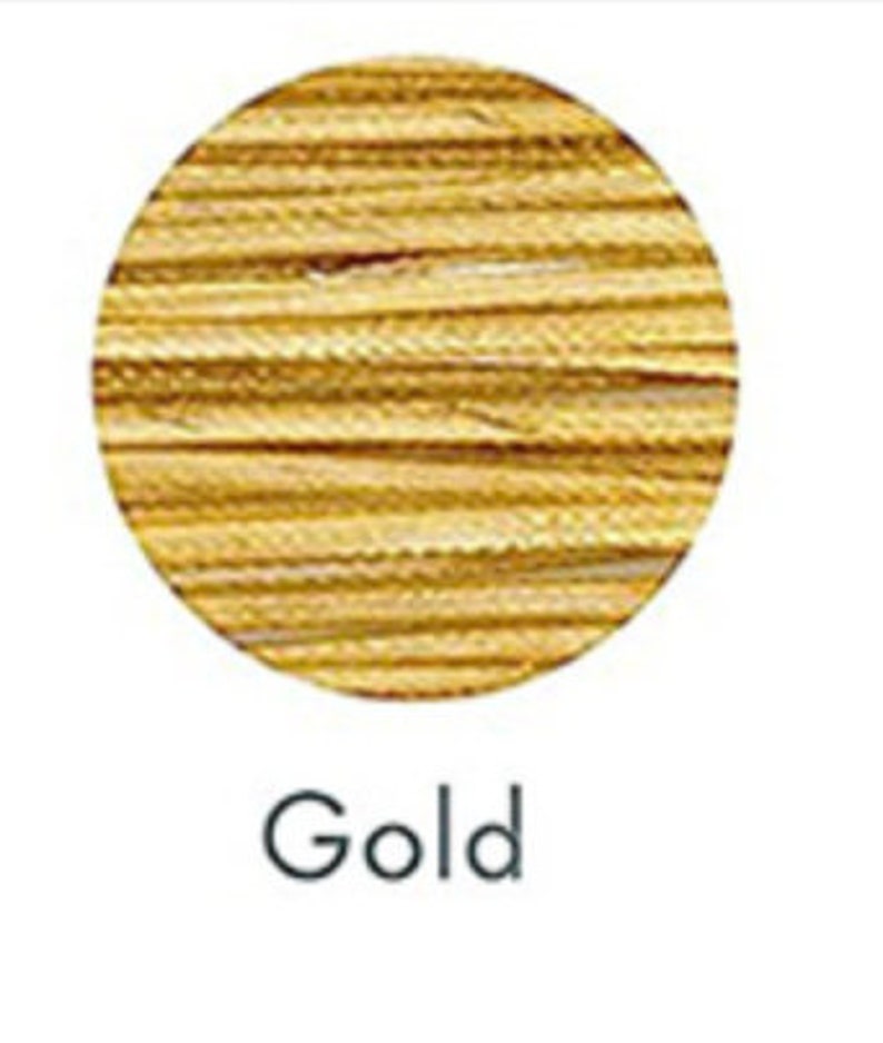 May include: A circular image featuring a textured gold surface. The word "Gold" is written in a simple, black font below the circle. The gold color has a metallic sheen.