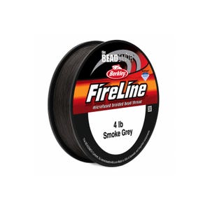 May include: A spool of smoke grey microfused braided bead thread by The Beadsmith and Berkley. The label features the text FireLine, 4 lb, and Smoke Grey. The spool is black with a red and white graphic design on the front circular face.
