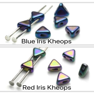 May include: Two sets of iridescent glass beads in the shape of triangles. The top set is blue and the bottom set is red.