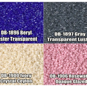 May include: Four different colors of seed beads, each in a separate square. The top left square is filled with blue beads, labeled "DB-1896 Beryl Luster Transparent". The top right square is filled with gray beads, labeled "DB-1897 Gray Transparent Luster". The bottom left square is filled with ivory beads, labeled "DB-1900 Ivory Crystal Ceylon". The bottom right square is filled with pink beads, labeled "DB-1906 Rosewater Opaque Glazed".