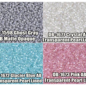 May include: Four different colors of seed beads.  The beads are small and round, and they are arranged in a grid pattern.  The colors are: ghost gray, crystal AB, glacier blue AB, and pink AB.  The text on the image reads: DB-1598 Ghost Gray AB Matte Opaque, DB-1671 Crystal AB Transparent Pearl Lined, DB-1672 Glacier Blue AB Transparent Pearl Lined, DB-1673 Pink AB Transparent Pearl Lined.