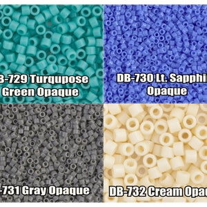 May include: Close-up of four different colors of opaque seed beads. The colors are turquoise green, light sapphire blue, gray, and cream. The beads are arranged in a grid pattern.