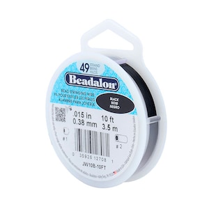 May include: A spool of black Beadalon bead stringing wire. The spool is labeled with the wire size, 0.015 inches or 0.38 millimeters, and the length, 10 feet or 3.5 meters. The spool is also labeled with the brand name, Beadalon, and the color, black.