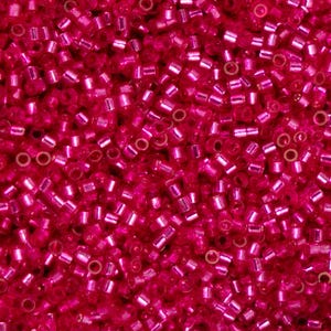 May include: A close-up shot of a mass of small, cylindrical, hot pink glass beads. The beads are tightly packed, forming a textured surface. They have a shiny, reflective appearance, and are used for jewellery making and crafts.