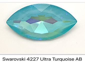 May include: A marquise-shaped Swarovski 4227 crystal in an ultra turquoise color with an AB finish. The faceted gemstone displays geometric patterns with light blue and dark blue reflections across its surface. The text Swarovski 4227 Ultra Turquoise AB is printed below the crystal.