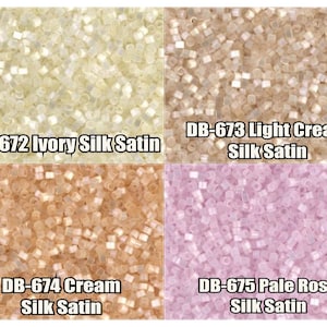 May include: Four samples of seed beads in ivory, light cream, cream, and pale rose colors. Each sample is labeled with the color and the text "Silk Satin".