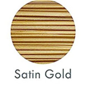 May include: A circular, gold-colored object with horizontal lines, labeled "Satin Gold" in a handwritten font. The object appears to be made of wood or a similar material, with a satin finish.