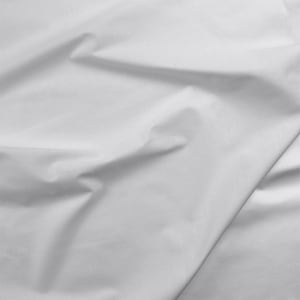 May include: White fabric with a smooth texture and soft folds. The fabric is wrinkled and has a slight sheen.