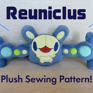 May include: A blue plush toy with a smiling face, two arms, and two appendages. The text "Reuniclus" is above the toy, and "Plush Sewing Pattern!" is below it. The toy has light blue, green, and yellow accents.