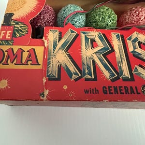 May include: Vintage box of Christmas lights with a red background and the text "KRISTMAS" in large, glittery letters. The box also features the text "with GENERAL ELECTRIC" and the General Electric logo.