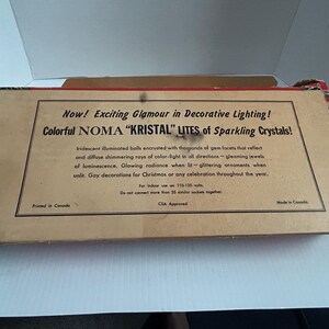 May include: A vintage box for NOMA "KRISTAL" LITES Christmas lights. The box is brown with red and white accents. The text on the box reads "Now! Exciting Glamour in Decorative Lighting! Colorful NOMA "KRISTAL" LITES of Sparkling Crystals!"  The box is printed in Canada and is CSA Approved.