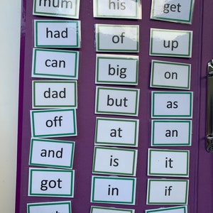 May include: A purple binder with clear pockets containing white cards with green borders. Each card has a high frequency word written in black text. The words are: mum, his, get, had, of, up, can, big, on, dad, but, as, off, at, an, and, is, it, got, in, if, not, back, him.