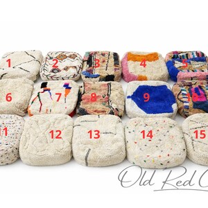 May include: A collection of fifteen square, textured poufs with various designs and colors. The poufs feature patterns like geometric shapes, stripes, and abstract designs in shades of white, beige, blue, pink, and orange. The text "Old Red City" is at the bottom.