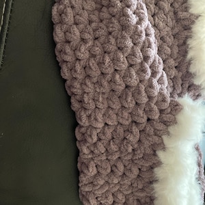 May include: Purple crocheted slippers with a white fluffy trim around the top edge.