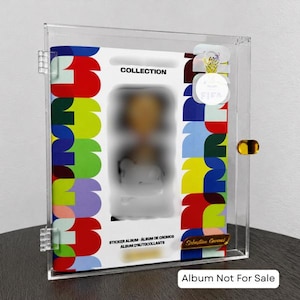 May include: A clear acrylic display case containing a sticker album with a colorful geometric pattern of red, blue, green, and yellow shapes. The album cover features the text COLLECTION, STICKER ALBUM, ALBUM DE CROMOS, and ALBUM D'AUTOCOLLANTS.