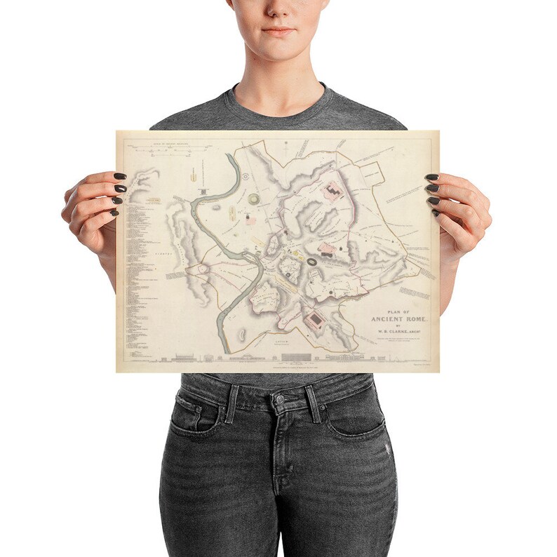 May include: A vintage map of Ancient Rome, printed on a cream-colored paper with brown and pink details. The map shows the city's layout with rivers, roads, and buildings. The title "Plan of Ancient Rome" is printed at the bottom.