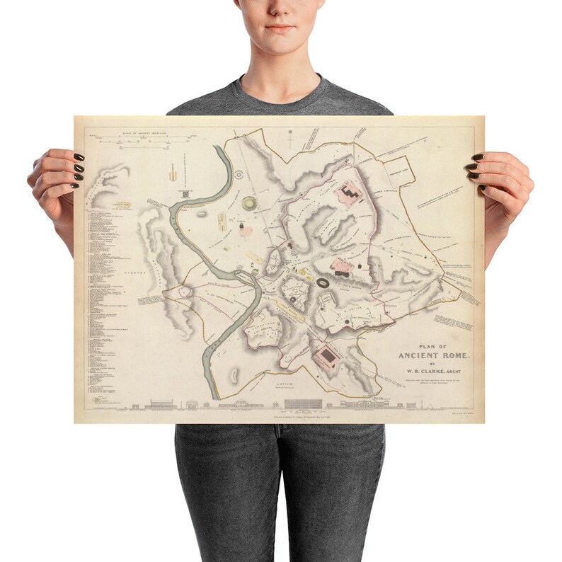 May include: A vintage map of Ancient Rome, printed on cream paper with brown and pink details. The map is titled "Plan of Ancient Rome" and includes the text "W.B. Clarke, Arch."